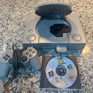 PlayStation one console with 128kg memory and a game